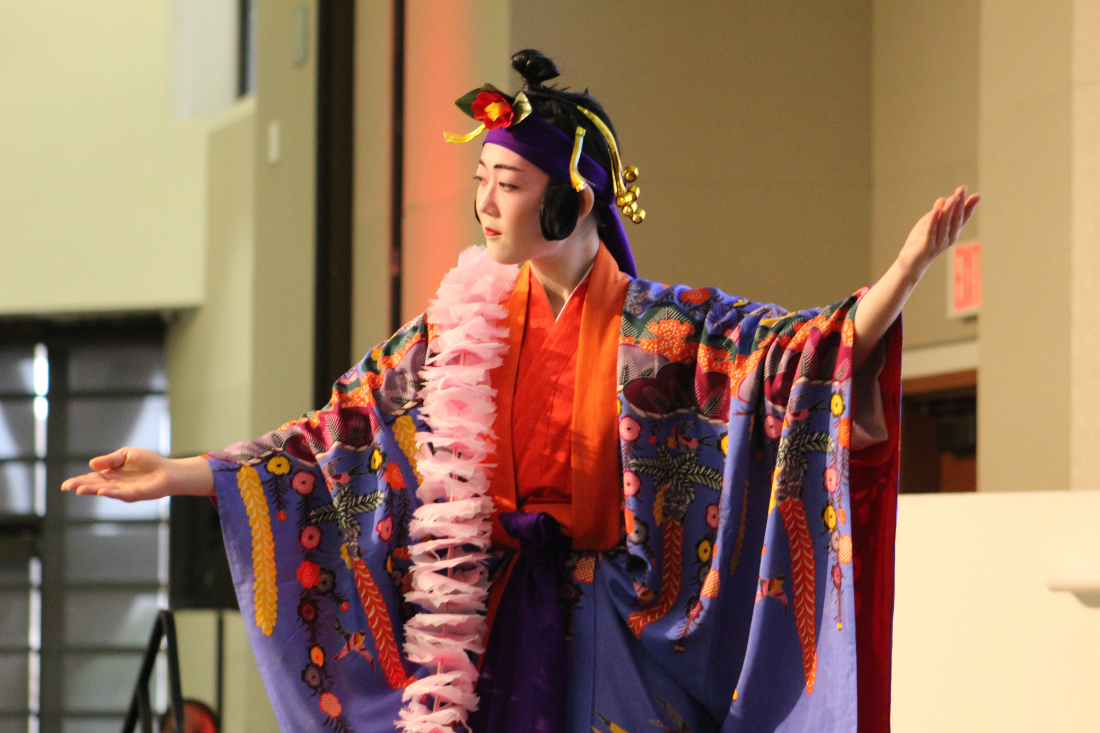 Female dancer dressed in traditional Okinawna Kimono performing during New Year's Party
